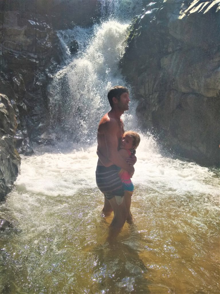 Dad and daughter enjoying the refreshing cool water on a hot day!