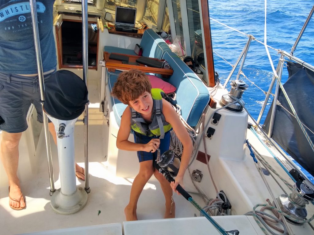 Nathan helping to reel in the huge blue striped Marlin