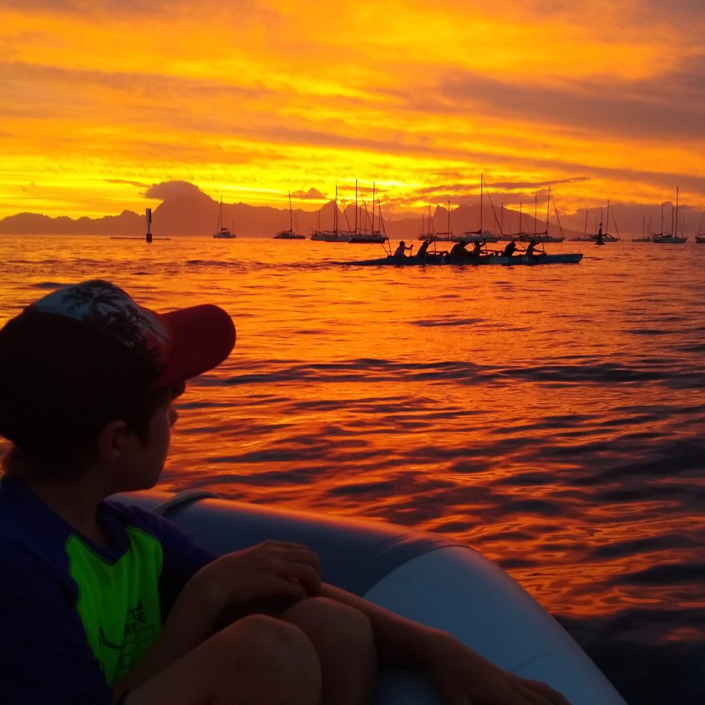 Watching the outriggers in the Marina Taina anchorage at sunset to a background of drumming from the shore. Amazing!