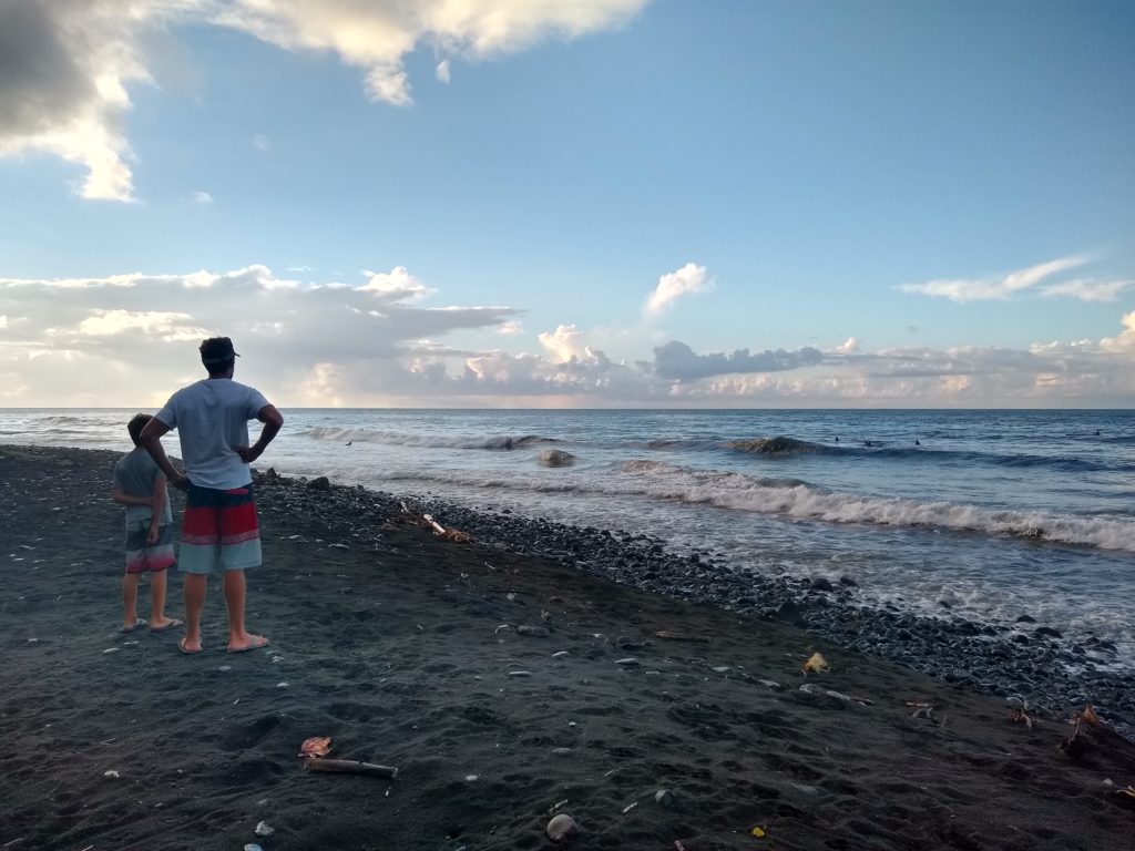 Checking out the surf at the black sand beach south of Point Venus. We returned here to catch a few waves. It was fun and locals were so patient and friendly with us!