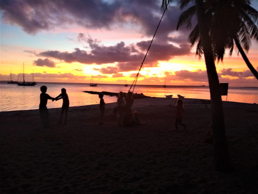 Kids playing at sunset.